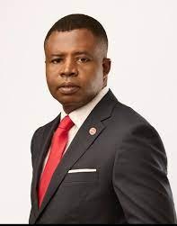 A worried man in a gray shirt holds a credit card, symbolizing online fraud or financial stress.